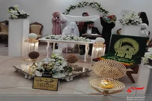 پرچم بارگاه منور رضوی بر سر سفره عقد زوج دانشجو در زاهدان
